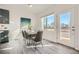 Bright dining area with a modern table set, large windows, and a door leading to the outdoor space at 15336 W 68Th Loop, Arvada, CO 80007