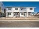 Modern townhomes featuring a two-story design, brick accents, and ample natural light from multiple windows at 15336 W 68Th Loop, Arvada, CO 80007