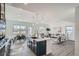 Open-concept kitchen with a central island, modern appliances, seamlessly connected to the living and dining areas at 15336 W 68Th Loop, Arvada, CO 80007