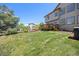 Lush backyard featuring a spacious lawn and deck with grill, perfect for outdoor entertaining at 4467 Trailside Ln, Castle Rock, CO 80109
