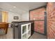 Basement featuring a bar area with brick accent wall and storage at 4467 Trailside Ln, Castle Rock, CO 80109