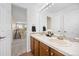 Bright bathroom featuring a double sink vanity with wood cabinets and neutral countertops at 4467 Trailside Ln, Castle Rock, CO 80109