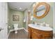 Bathroom featuring a vanity with round mirror, toilet, and walk-in shower at 4467 Trailside Ln, Castle Rock, CO 80109