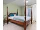 A serene bedroom with green walls, a canopy bed, soft carpet, and natural lighting at 4467 Trailside Ln, Castle Rock, CO 80109