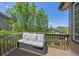 Outdoor deck with comfortable seating and views of surrounding trees and neighborhood homes at 4467 Trailside Ln, Castle Rock, CO 80109