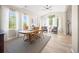 Spacious dining room with hardwood floors, a wooden table, and large windows offering abundant natural light, ideal for entertaining at 4467 Trailside Ln, Castle Rock, CO 80109