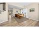 Bright dining room with hardwood floors, a large wooden table, and lots of natural light, perfect for Gathering gatherings at 4467 Trailside Ln, Castle Rock, CO 80109