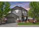 Charming two-story home with a well-manicured lawn, brick accents, and a two-car garage, perfect for suburban living at 4467 Trailside Ln, Castle Rock, CO 80109