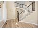 Elegant foyer with hardwood floors, a staircase with a black railing, and ample natural light streaming through large windows at 4467 Trailside Ln, Castle Rock, CO 80109