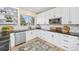 Bright, updated kitchen featuring white cabinets, stainless steel appliances, and a black countertop at 4467 Trailside Ln, Castle Rock, CO 80109