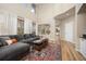 Spacious living room with high ceilings, many windows, and open access to the dining area and kitchen at 4467 Trailside Ln, Castle Rock, CO 80109