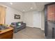 Well-lit living room area featuring a comfortable sofa and stylish flooring at 4467 Trailside Ln, Castle Rock, CO 80109