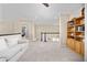 Comfortable loft area with a white sofa, neutral walls, and a built-in wooden bookcase at 4467 Trailside Ln, Castle Rock, CO 80109