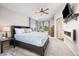 Beautiful main bedroom with a king bed, ceiling fan, and modern electric fireplace at 4467 Trailside Ln, Castle Rock, CO 80109