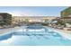 Resort-style pool surrounded by lounge chairs and umbrellas, perfect for relaxation and entertainment at 185 Steele St # 211, Denver, CO 80206