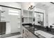 Modern bathroom featuring dual sinks, white subway tile, and a sleek glass-enclosed shower at 6396 Nelson Ct, Arvada, CO 80004