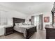 Relaxing bedroom features a queen bed, side tables, artwork, and plenty of natural light at 6396 Nelson Ct, Arvada, CO 80004
