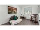 Comfortable room featuring unique seating, decor, and wood-look flooring at 6396 Nelson Ct, Arvada, CO 80004