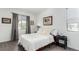 Bright bedroom with a neutral color palette, wood-look flooring, and ample natural light from a window at 6396 Nelson Ct, Arvada, CO 80004