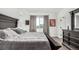 Comfortable bedroom featuring a queen bed, dresser, and modern decor with gray accents at 6396 Nelson Ct, Arvada, CO 80004