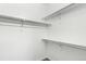 Empty walk-in closet with installed shelves and hanging rods for maximum organization at 6396 Nelson Ct, Arvada, CO 80004