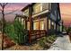 Beautiful brick and siding exterior with a wooden deck and lush landscaping at sunset at 6396 Nelson Ct, Arvada, CO 80004