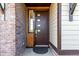 Modern home featuring a stylish front door with a sidelight and mixed material facade of brick and siding at 6396 Nelson Ct, Arvada, CO 80004