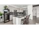 Stylish kitchen with gray cabinets, granite countertops, stainless steel appliances, and wine cooler at 6396 Nelson Ct, Arvada, CO 80004