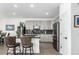 Modern kitchen featuring sleek gray cabinetry, stainless steel appliances, and breakfast bar seating at 6396 Nelson Ct, Arvada, CO 80004