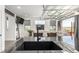 Close up of a modern kitchen sink and countertop, looking out to a stylish living area at 6396 Nelson Ct, Arvada, CO 80004