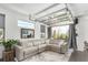 Bright living room features a glass garage door opening to the outdoors and a comfortable sectional sofa at 6396 Nelson Ct, Arvada, CO 80004