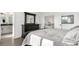 Cozy primary bedroom with soft bedding, dresser, and natural light pouring in from large doors at 6396 Nelson Ct, Arvada, CO 80004