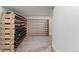 Spacious wine cellar with custom-built wooden racks for ample bottle storage on carpeted floor at 6396 Nelson Ct, Arvada, CO 80004