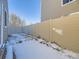 Small, fenced backyard with patchy grass and snow at 11860 Harrison St, Thornton, CO 80233