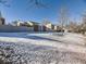 Snow covered backyard with a view of neighboring homes at 11860 Harrison St, Thornton, CO 80233