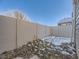 Private backyard with snow-covered ground and tall fence at 11860 Harrison St, Thornton, CO 80233