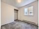 Simple bedroom with neutral walls, carpet, and a window at 11860 Harrison St, Thornton, CO 80233