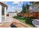 Backyard featuring stone pavers, manicured lawn, and a shed for outdoor storage at 338 Mt Wilson St, Brighton, CO 80601