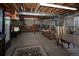 Finished basement with concrete flooring, bar-style seating, and a comfortable lounge area at 338 Mt Wilson St, Brighton, CO 80601