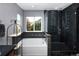 Well-lit bathroom featuring a soaking tub, glass-enclosed shower, and tiled accents, creating a spa-like experience at 338 Mt Wilson St, Brighton, CO 80601