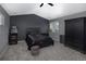 Bedroom featuring a dark accent wall, ceiling fan, and carpet, ideal for relaxation and entertainment at 338 Mt Wilson St, Brighton, CO 80601