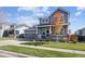 Inviting two-story home with a well-manicured lawn and a welcoming covered porch at 338 Mt Wilson St, Brighton, CO 80601