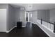 Hallway with dark hardwood floors, white trim, and neutral gray walls, creating a transitional space at 338 Mt Wilson St, Brighton, CO 80601