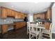 Bright kitchen featuring wood cabinetry, an island, and a dining area at 338 Mt Wilson St, Brighton, CO 80601