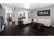 Bright and airy living room featuring hardwood floors, modern furnishings, and elegant archways at 338 Mt Wilson St, Brighton, CO 80601