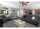 Spacious living room showcasing hardwood floors and gray furniture at 338 Mt Wilson St, Brighton, CO 80601