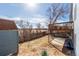 This backyard features a wooden deck, a small shed and a fence with views of the surrounding land at 17665 E Temple Dr, Aurora, CO 80015