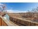 A wide wooden deck overlooks a fenced backyard, providing a peaceful outdoor retreat at 17665 E Temple Dr, Aurora, CO 80015