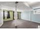 This bright basement features neutral carpet, painted concrete ceiling, and a walkout to the backyard at 17665 E Temple Dr, Aurora, CO 80015