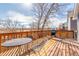 A wide wooden deck offers a perfect spot for outdoor dining and grilling with beautiful natural views at 17665 E Temple Dr, Aurora, CO 80015